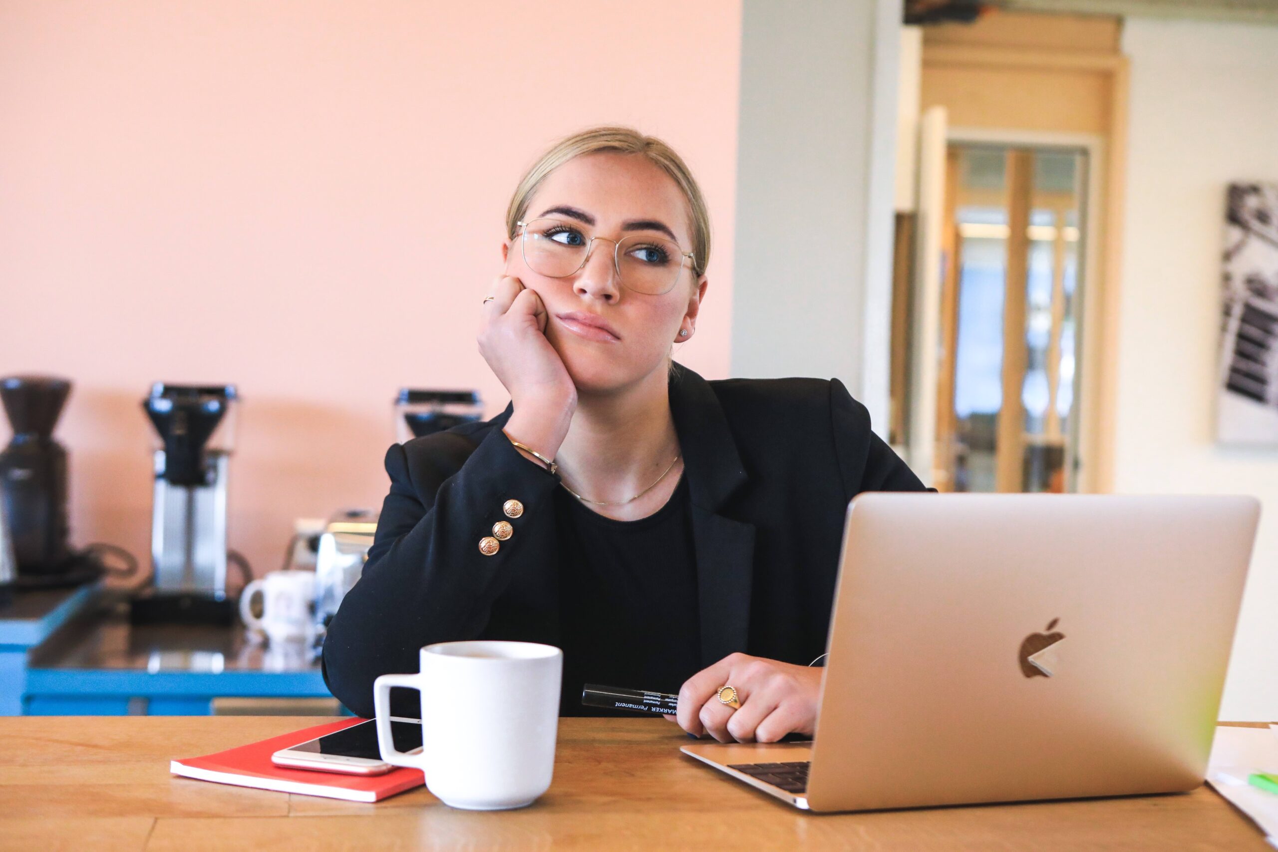 Woman daydreaming at her computer.