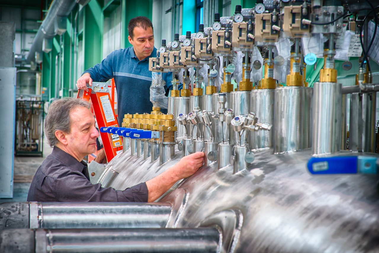 Two male temporary employees in factory.