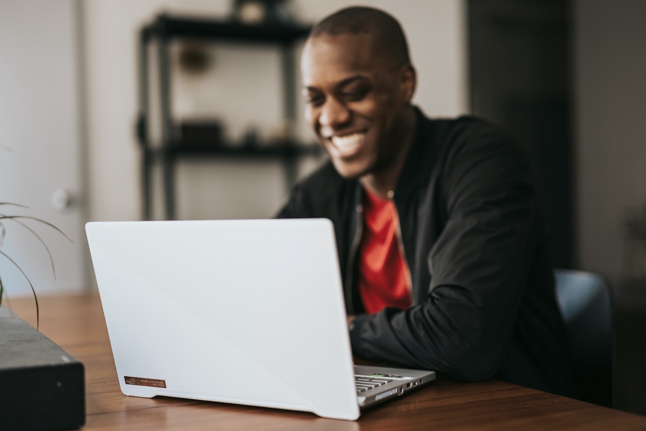 Man communicating with coworkers via laptop