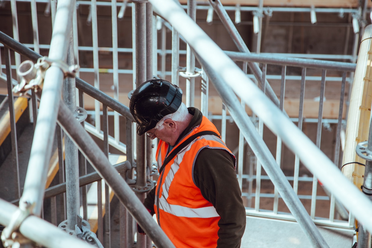 Man wearing PPE vest and hat.