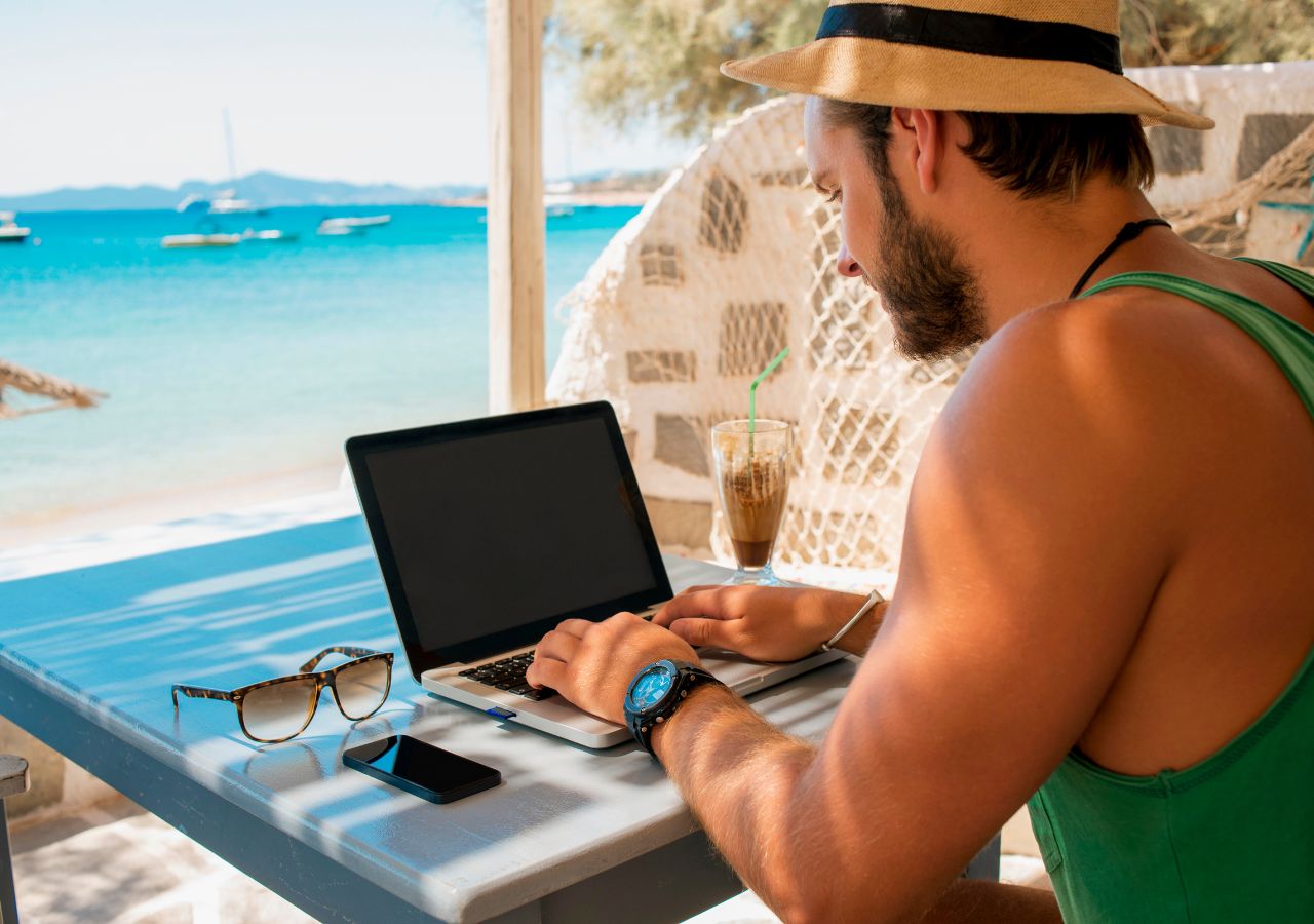 photo of man on a computer in the Caribbean to illustrate the cost of a bad hire