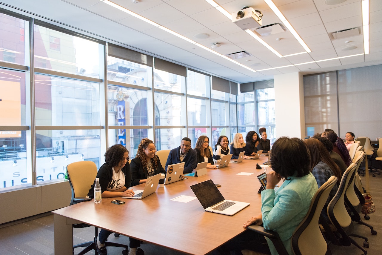 People gathered around a conference table illustrating ethical companies.