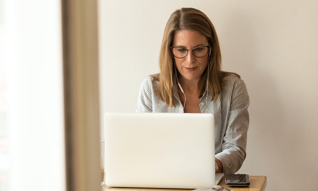 Middle aged woman typing illustrating finding work after age 50.