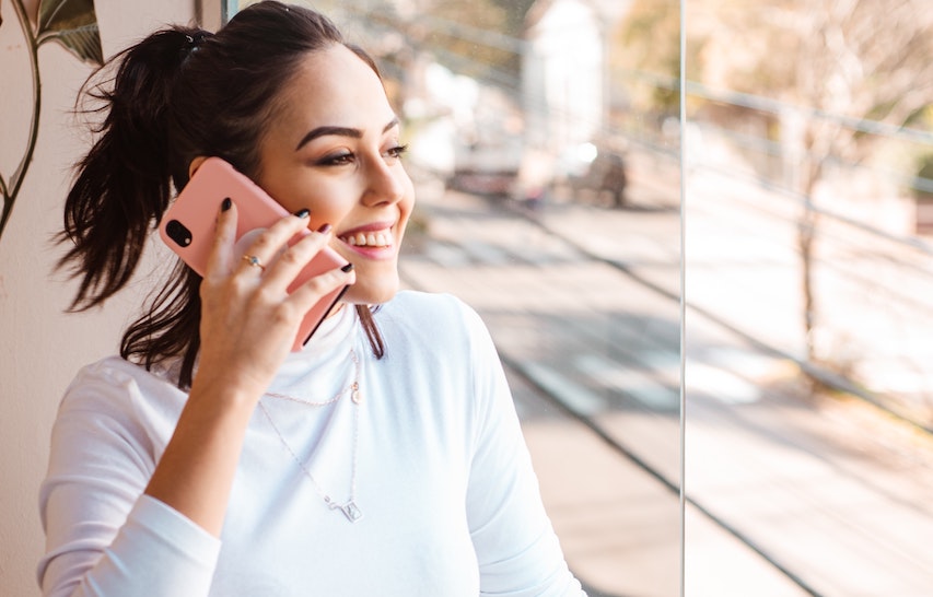 Woman on cell phone illustrating how to get hired faster.