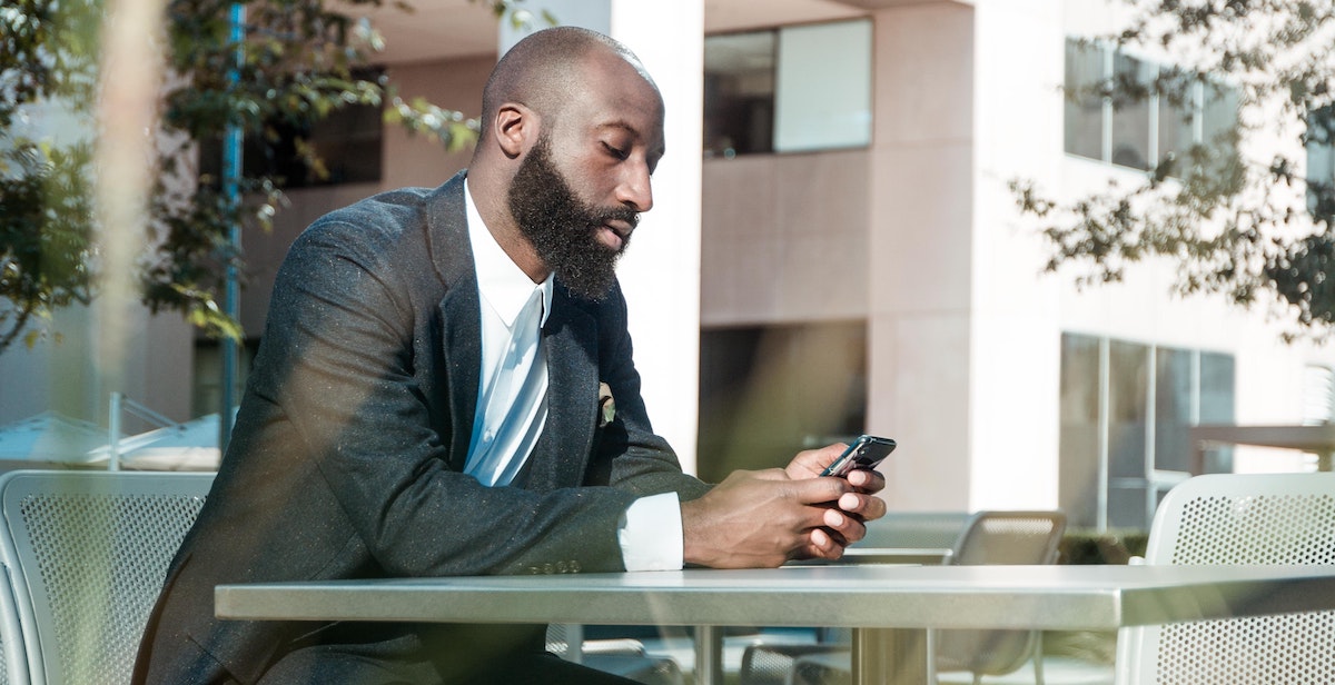 Picture of man looking at phone to illustrate Social Media Recruiting.