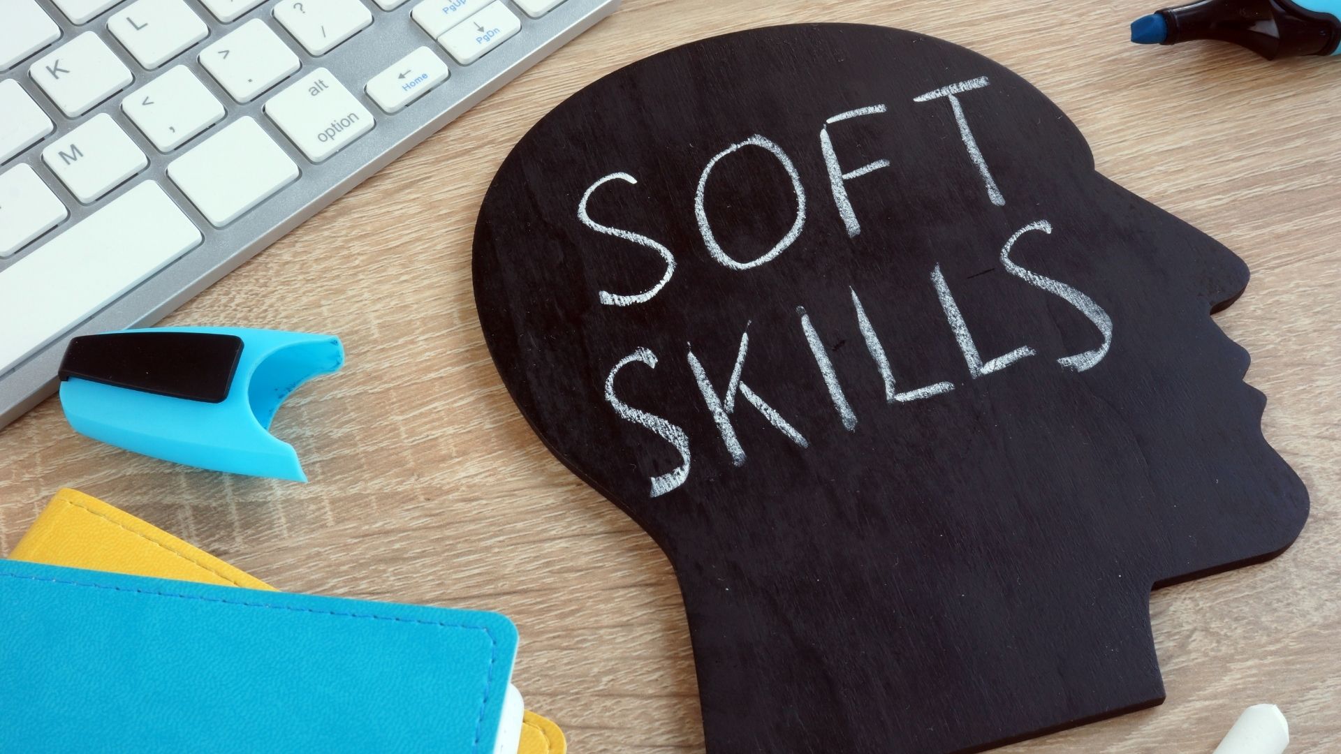 Photo of a head and computer keyboard to illustrate Soft Skills in the Workplace