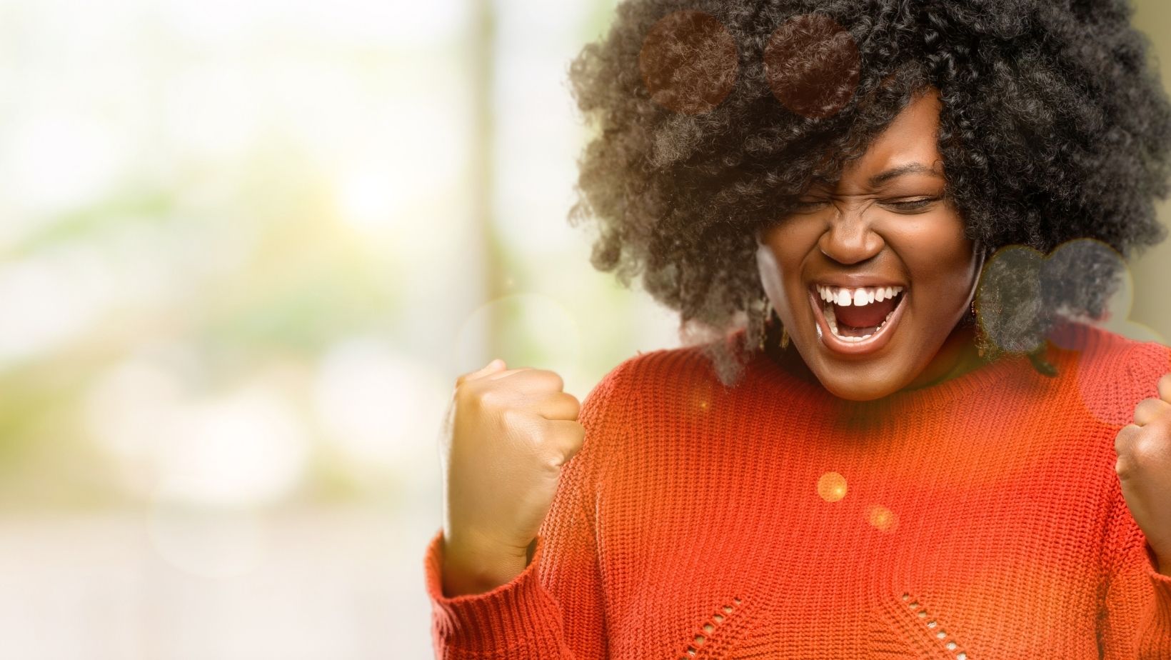 Photo of woman celebrating to illustrate entry level jobs.