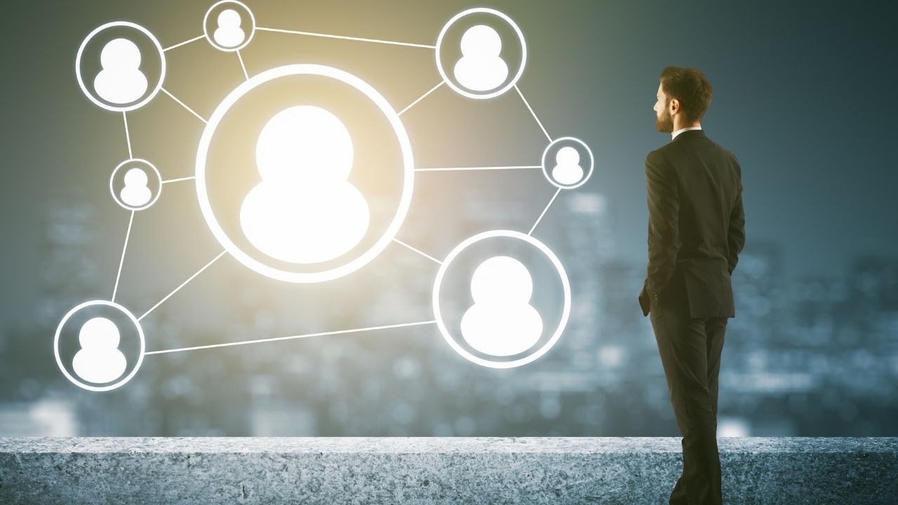 Slow Hiring Process Picture of man looking at different people to illustrate Slow Hiring Process.