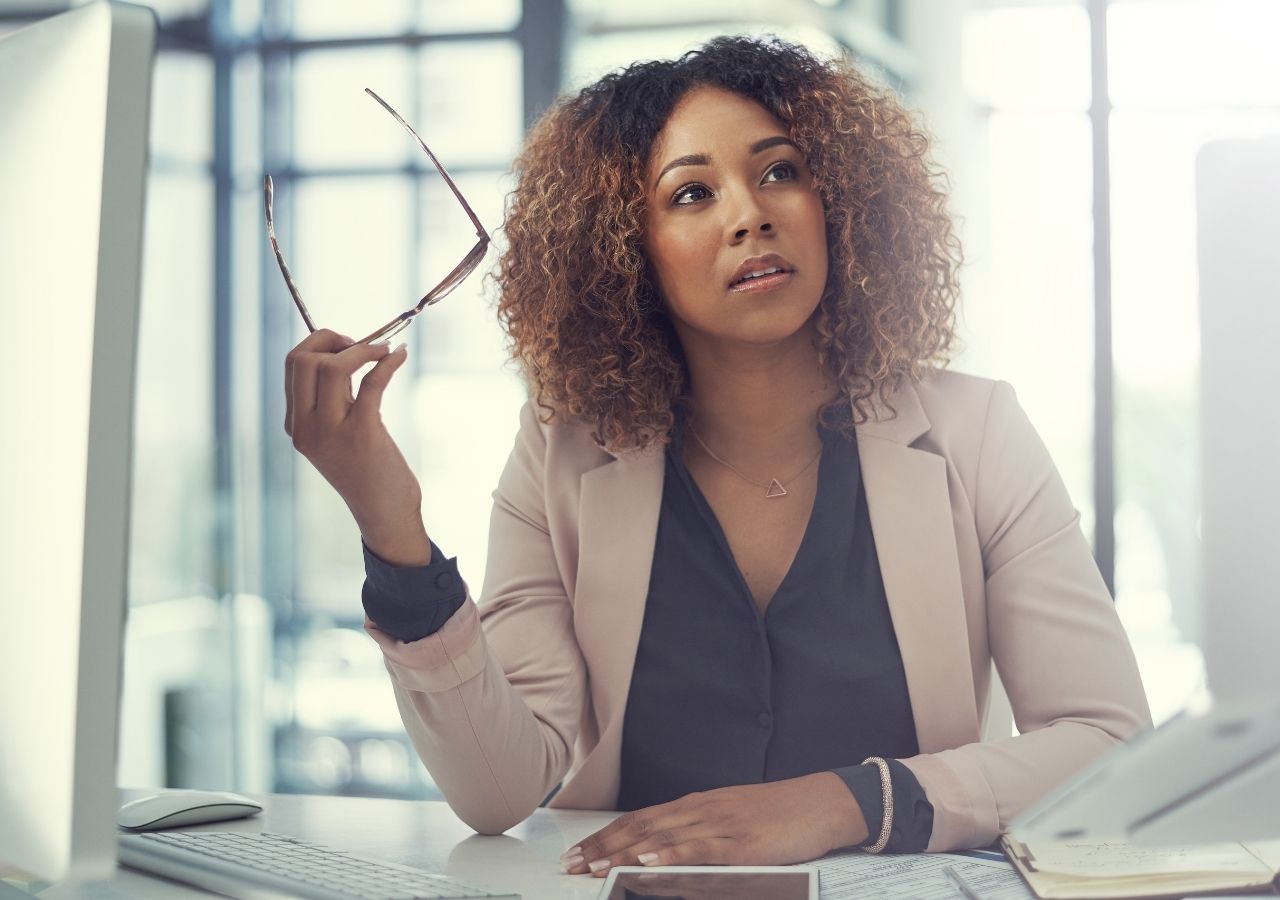 Photo of woman in deep thought to illustrate "How to Ask for a Promotion"