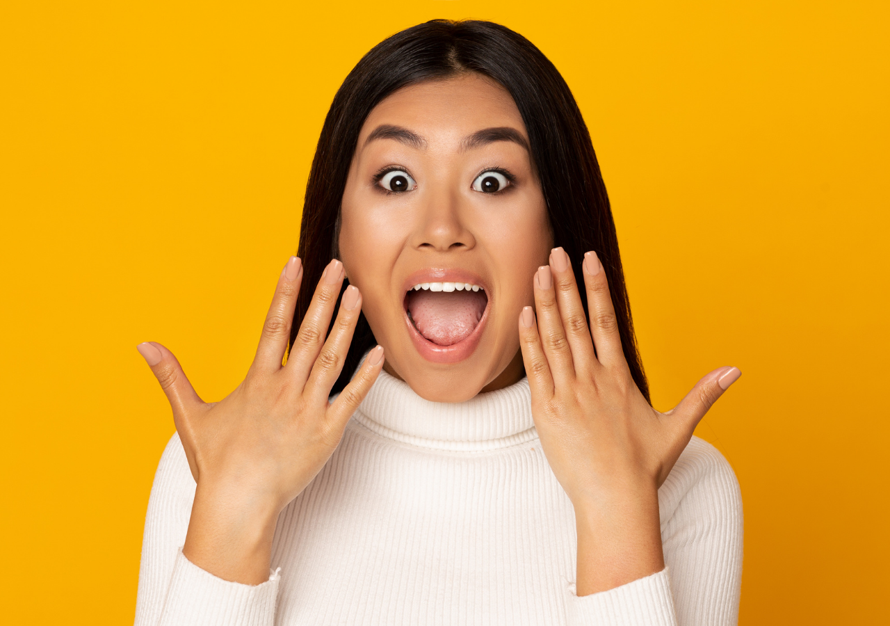 Photo of happy Asian woman to illustrate How to Wow Your Interviewer