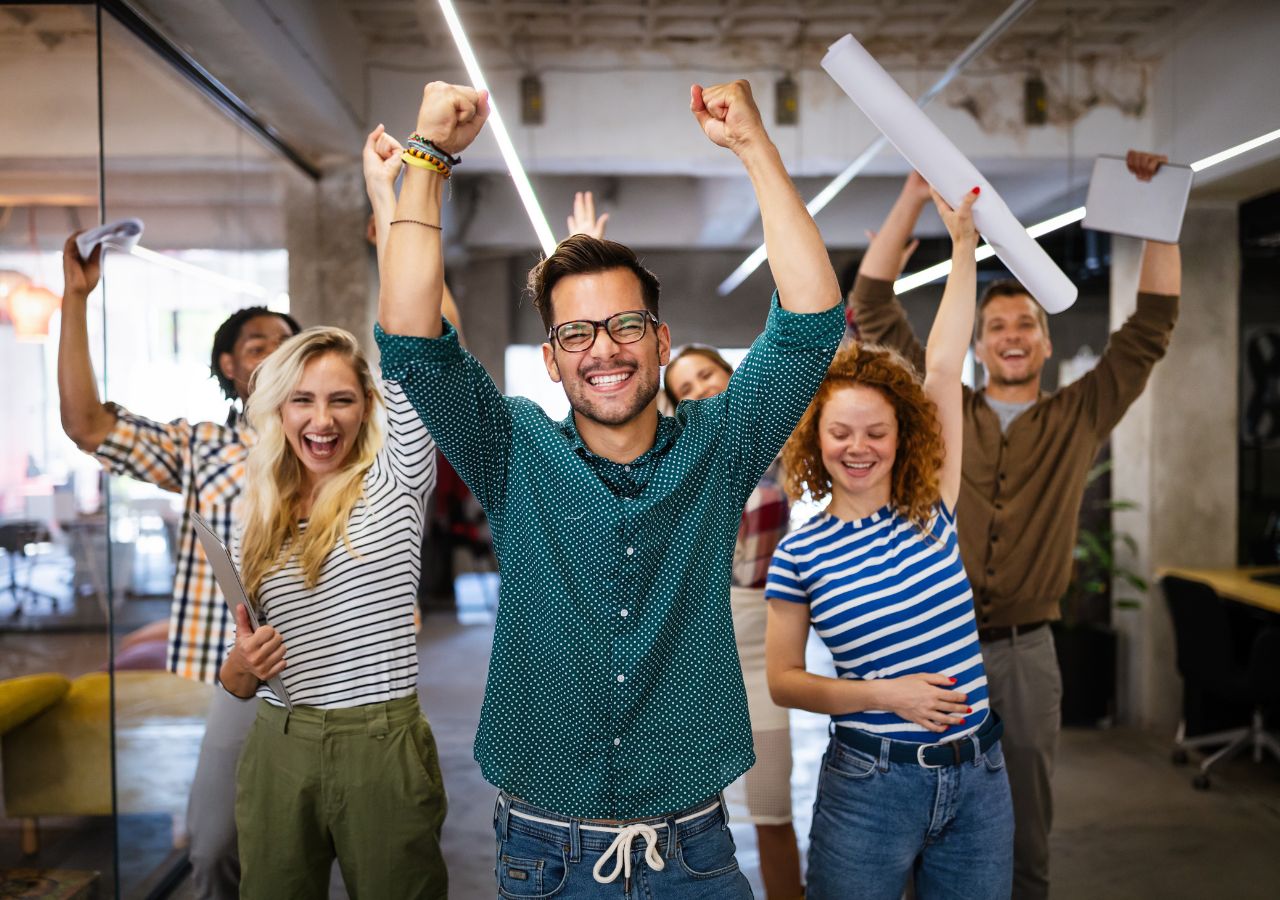 Photo of happy employees to illustrate "How to Reduce Turnover"