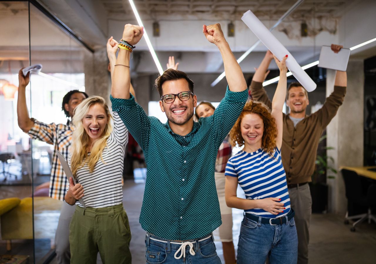 How to Reduce Turnover Photo of happy employees to illustrate "How to Reduce Turnover"