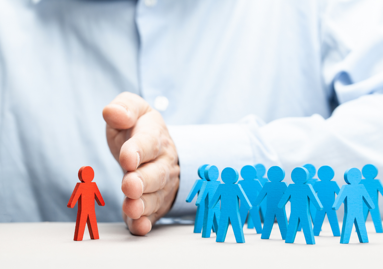 reduce overstaffing photo of small wooden people to illustrate how to reduce overstaffing