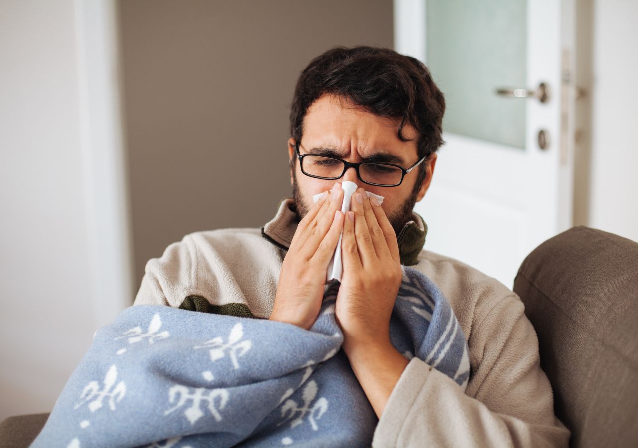 Photo of man blowing his nose to illustrate What to do if you used all your sick days