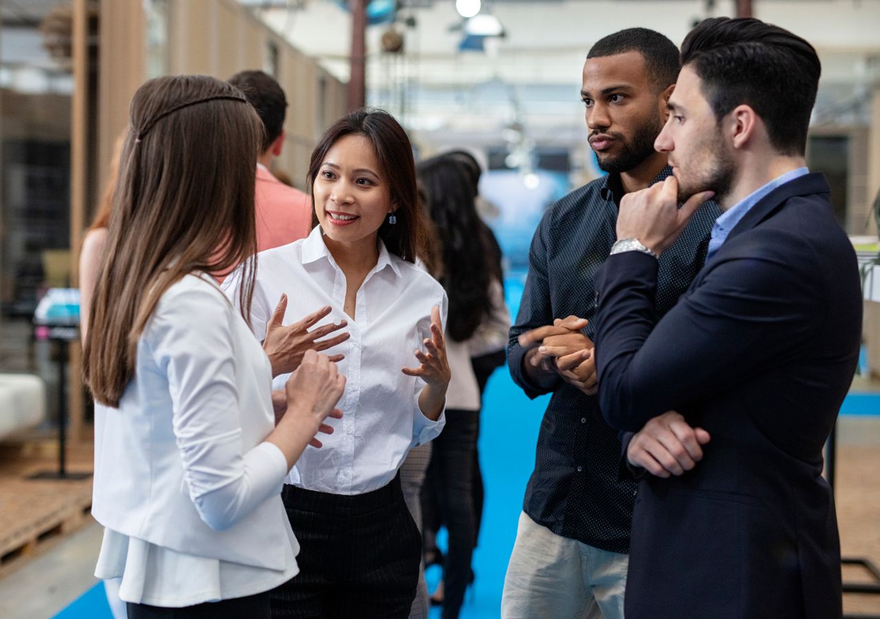 Photo of four people talking to illustrate why Networking in your field is important.