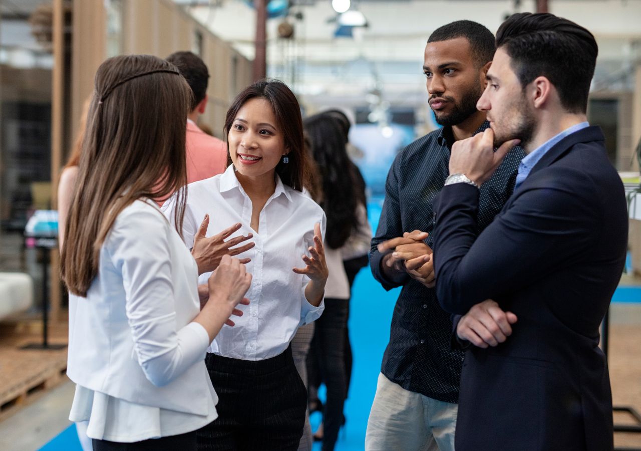 Networking in your field Photo of four people talking to illustrate why Networking in your field is important.