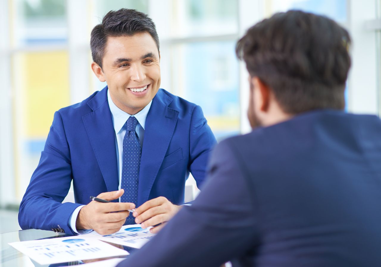 How Exit Interviews Could Help Your Retention Photo of men talking to illustrate How Exit Interviews Could Help Your Retention