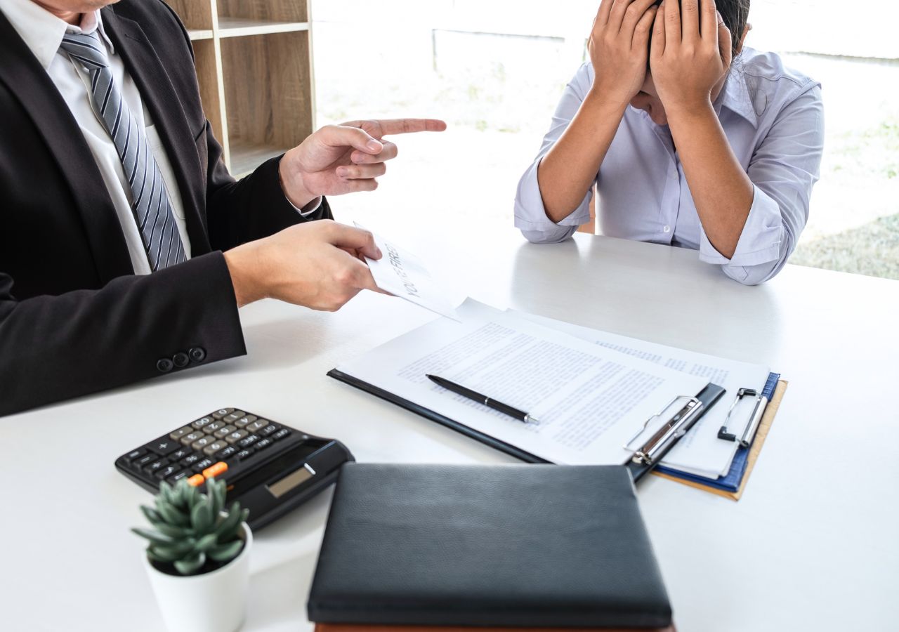 Photo of man covering eyes to illustrate when should you replace an employee