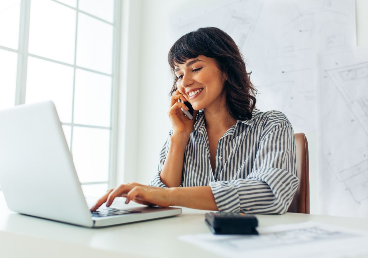 Photo of woman on laptop computer to illustrate questions to ask at your job interview.