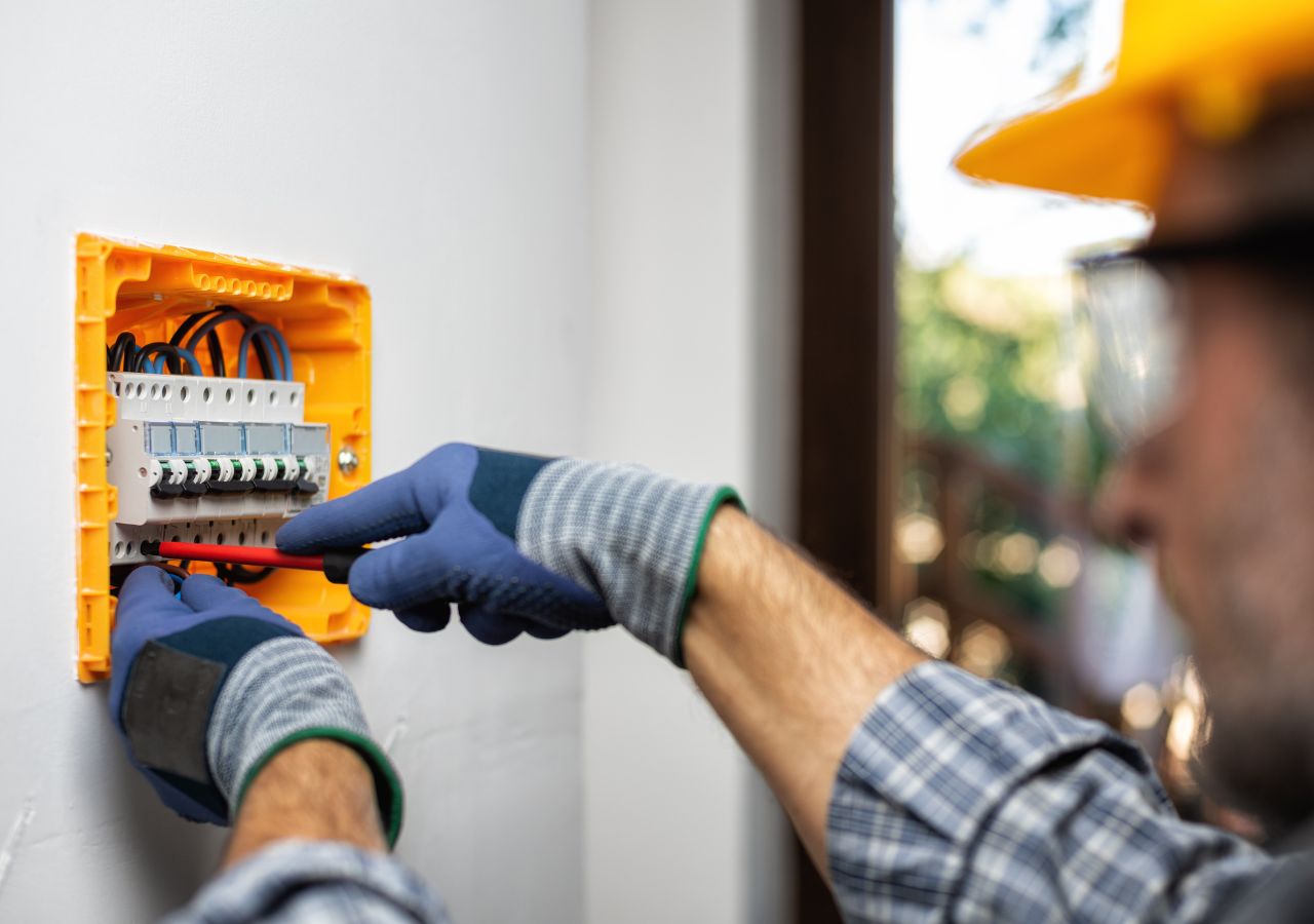 Photo of many working on electrical panel to illustrate why complacency is dangerous in the workplace.