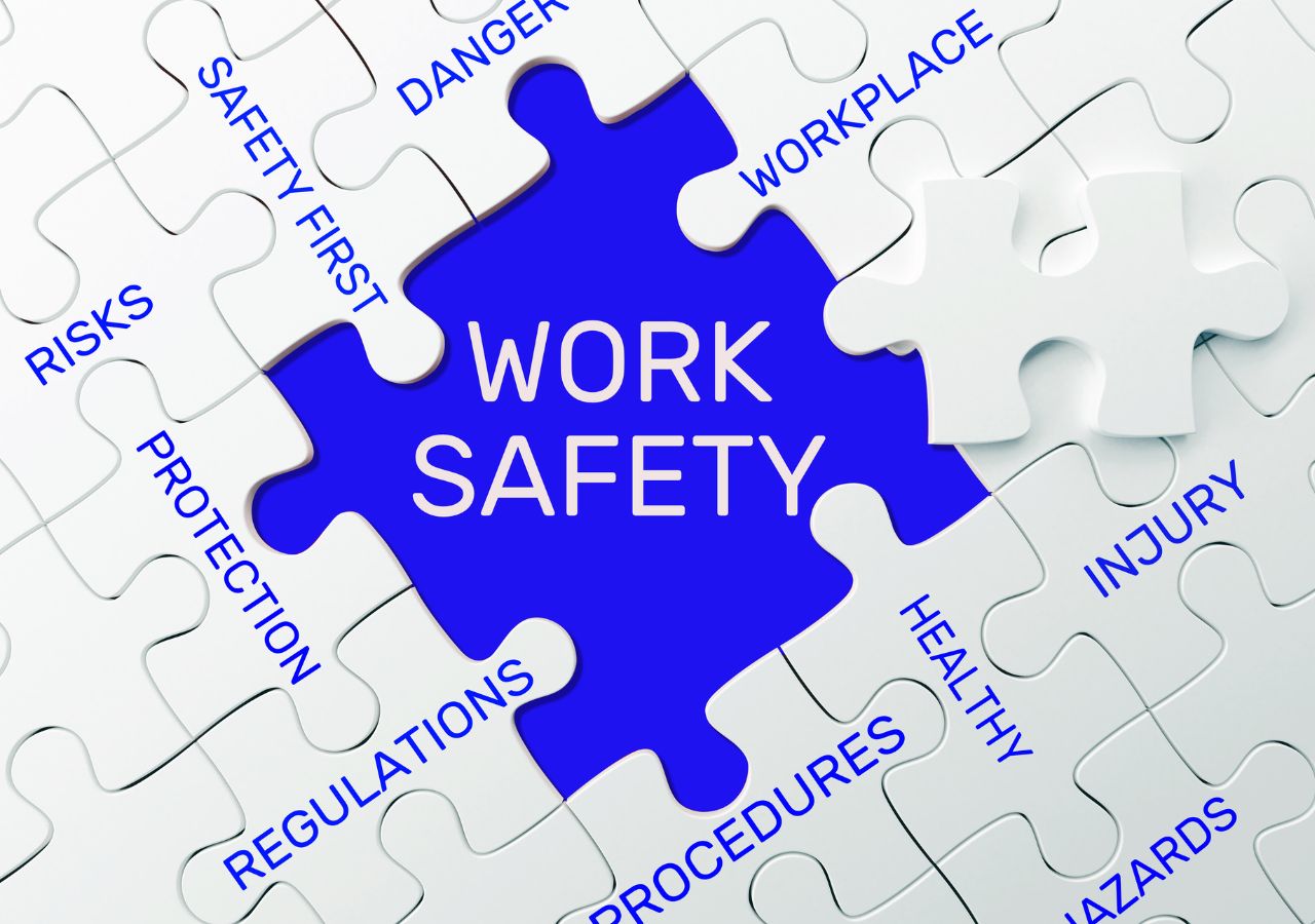 Puzzle pieces that say "work safety" to illustrate how to create a safe work environment.