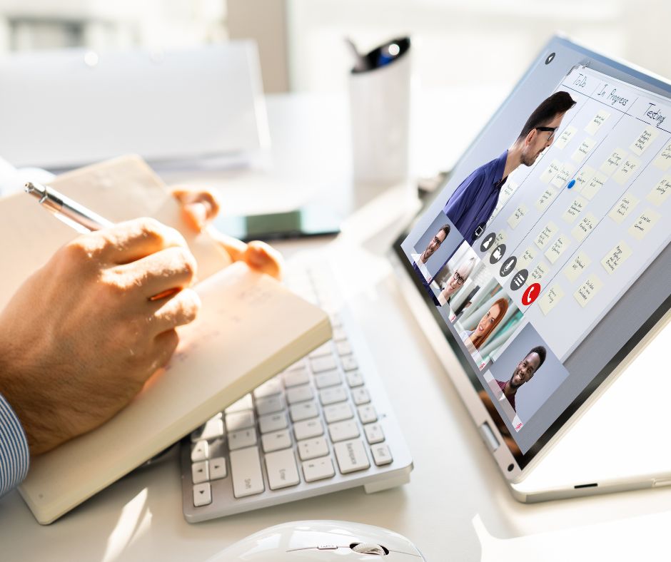 Photo of woman watching laptop and taking notes to illustrate business training videos.