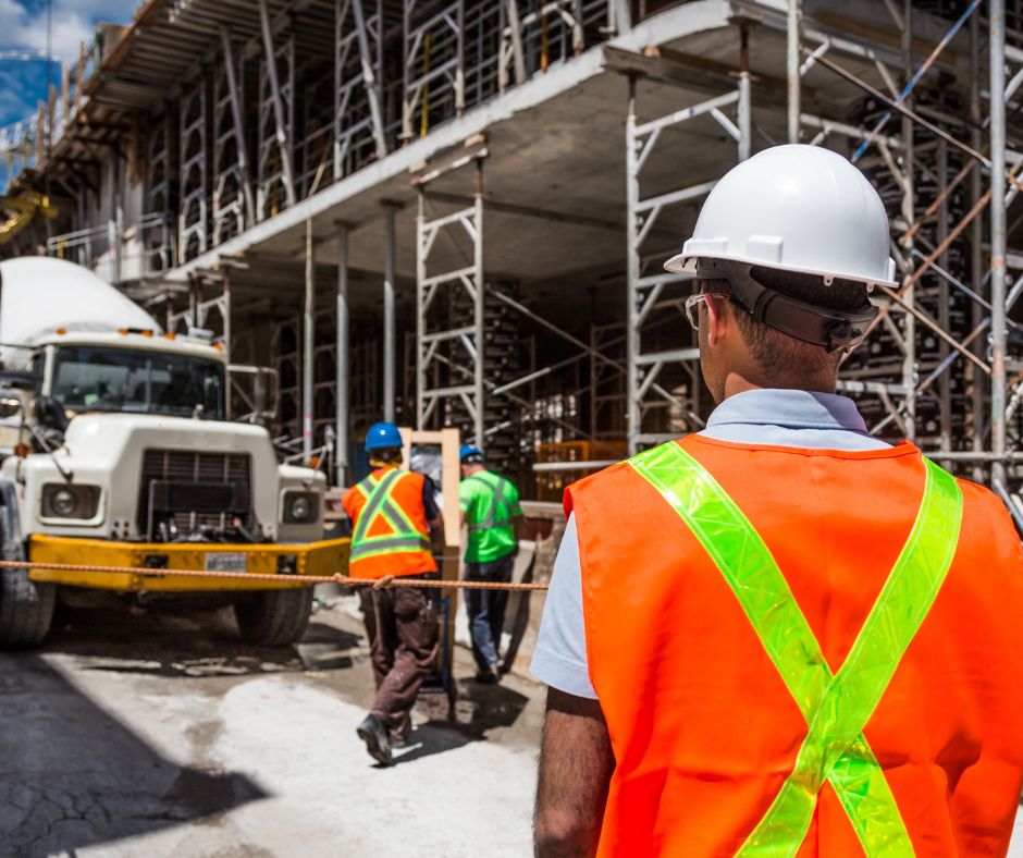 Your Safety Responsibilities As an Employer Photo of warehouse manager watching two other workers to illustrate Your Safety Responsibilities As an Employer.