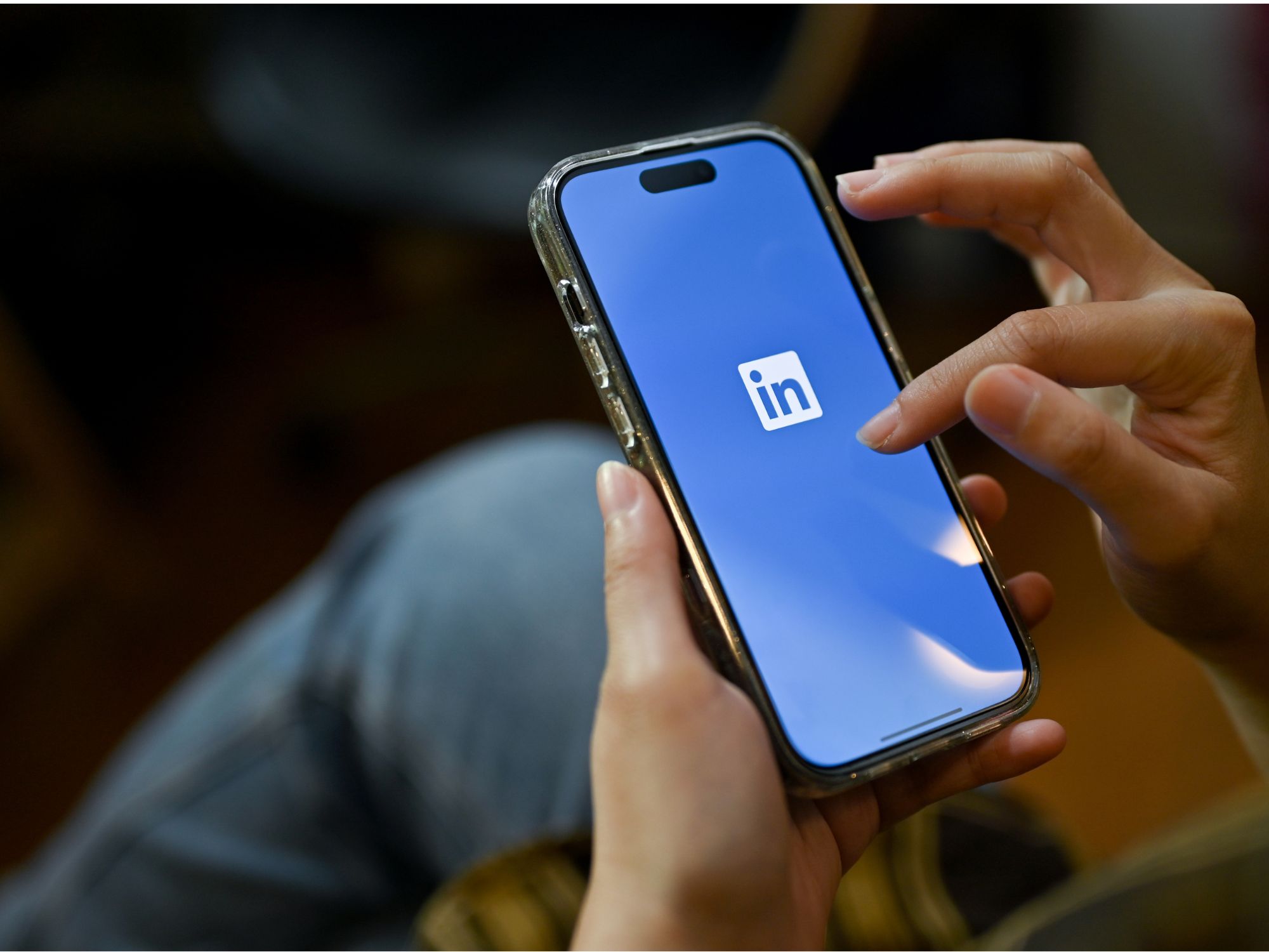 Photo of phone screen showing LinkedIn logo to illustrate social media networking in a job search.
